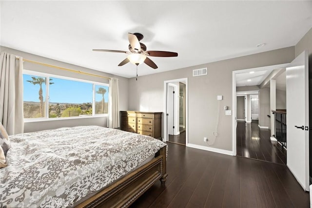 bedroom featuring a ceiling fan, baseboards, visible vents, and dark wood-type flooring