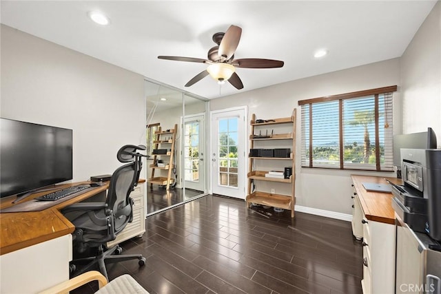 office space with dark wood-type flooring, recessed lighting, ceiling fan, and baseboards