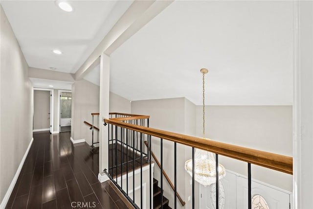 hallway featuring vaulted ceiling with beams, recessed lighting, an upstairs landing, baseboards, and wood tiled floor