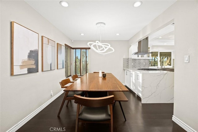 dining area with baseboards, dark wood finished floors, and recessed lighting