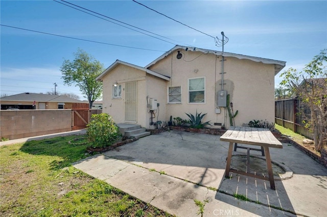 back of house featuring fence private yard, stucco siding, and a patio