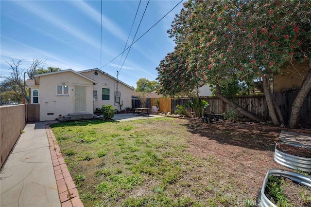 view of yard with a fenced backyard and a patio