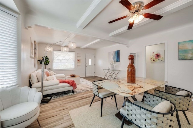 living area with ceiling fan with notable chandelier, beamed ceiling, and light wood-type flooring