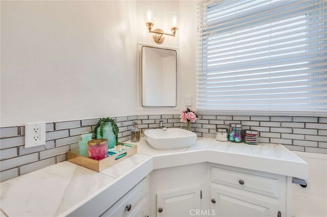 bathroom featuring vanity and decorative backsplash