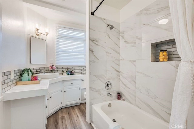 full bathroom featuring tasteful backsplash, shower / bathtub combination with curtain, toilet, vanity, and wood finished floors