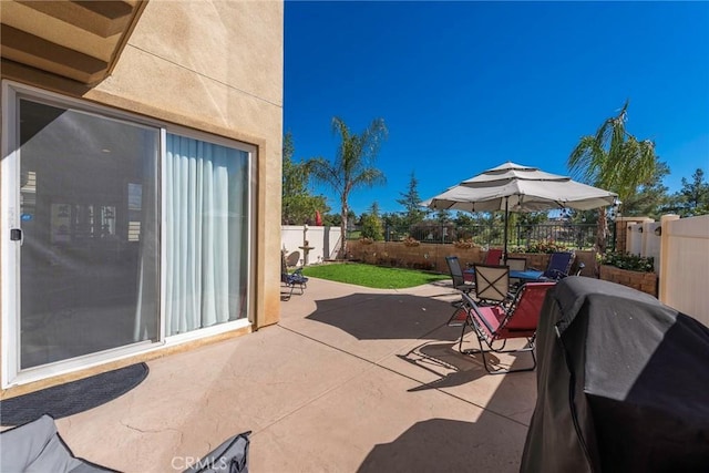 view of patio / terrace featuring outdoor dining area, a fenced backyard, and area for grilling