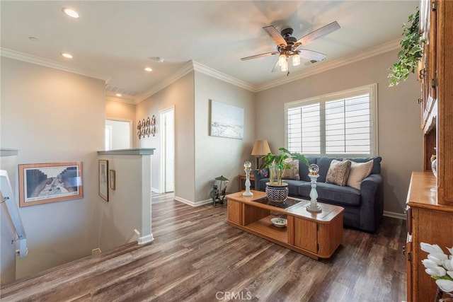 living area featuring dark wood-type flooring, crown molding, and baseboards