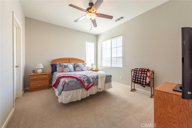 bedroom with visible vents, ceiling fan, light carpet, and baseboards