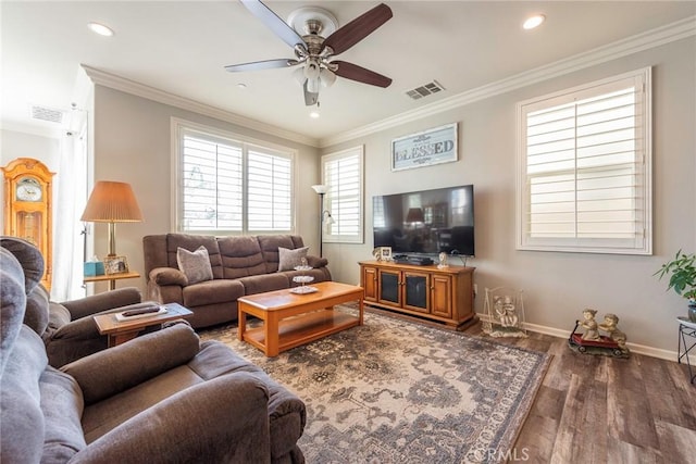 living area featuring ornamental molding and visible vents