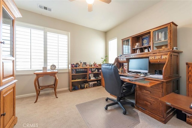 home office with light colored carpet, visible vents, ceiling fan, and baseboards