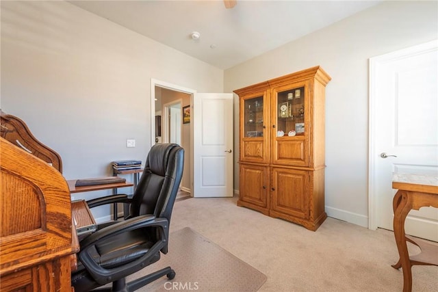 home office with light colored carpet and baseboards