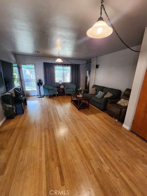 living area featuring light wood finished floors and baseboards