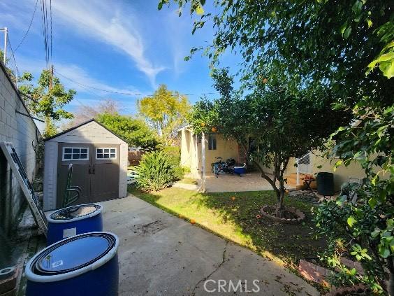 view of patio / terrace with an outbuilding and a storage shed