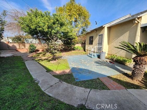 view of yard featuring a patio and a fenced backyard