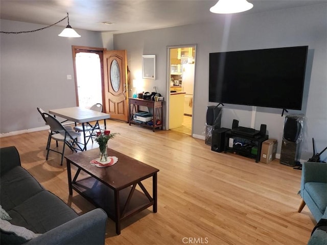 living room featuring light wood-type flooring and baseboards