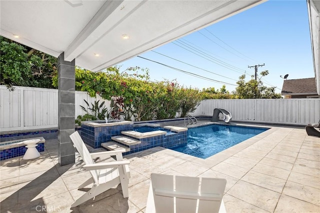 view of pool featuring a pool with connected hot tub, a fenced backyard, and a patio area