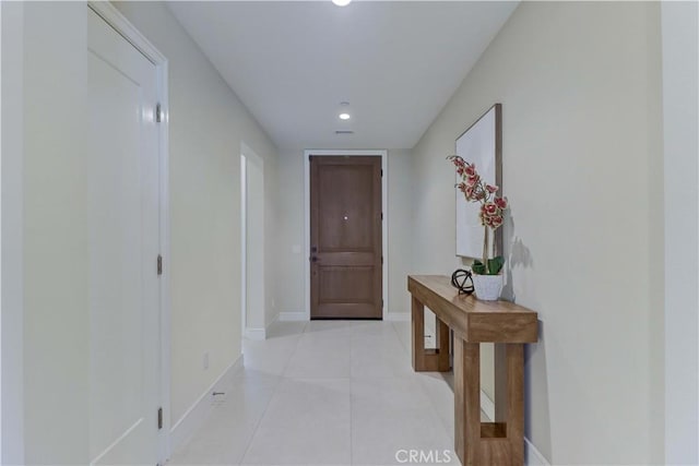 hall with light tile patterned floors and baseboards