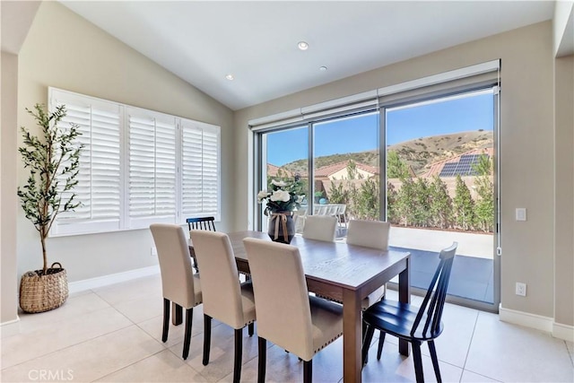 dining room with light tile patterned floors, baseboards, vaulted ceiling, and recessed lighting