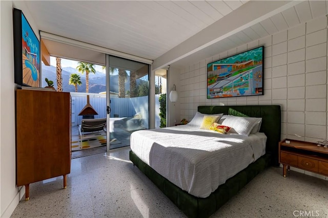 bedroom featuring light speckled floor and access to outside