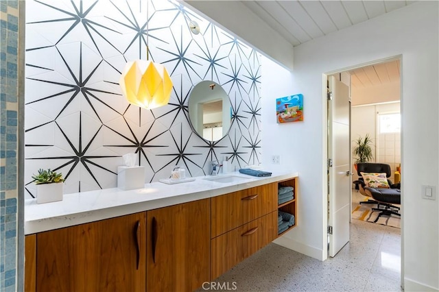 full bath featuring baseboards and vanity