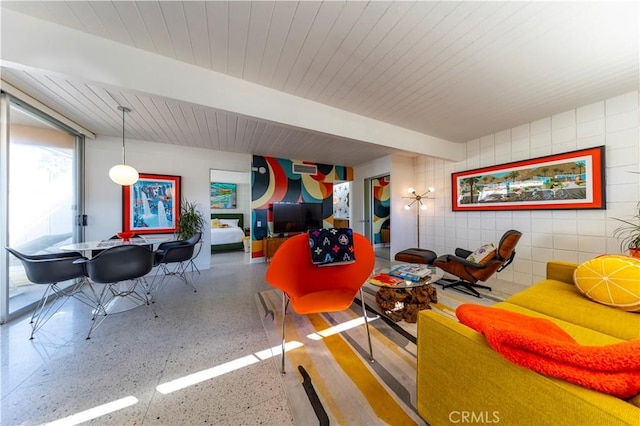 interior space featuring wooden ceiling, beamed ceiling, and speckled floor