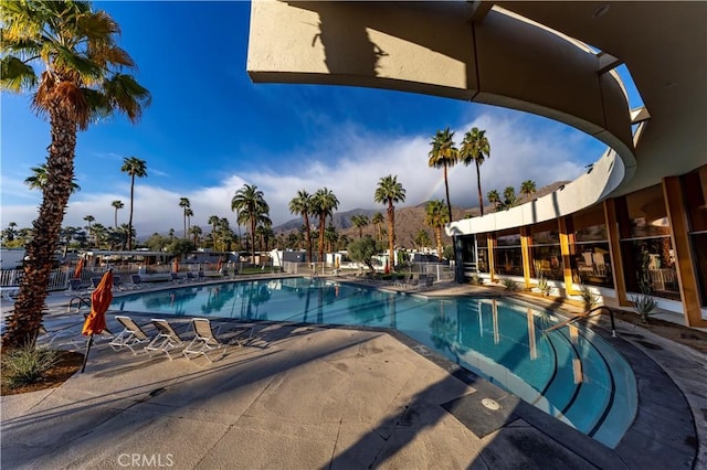 pool featuring a patio and a mountain view