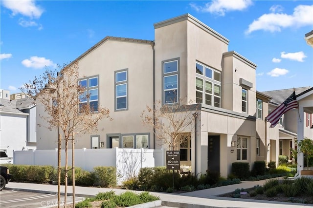 exterior space featuring uncovered parking, fence, and a residential view