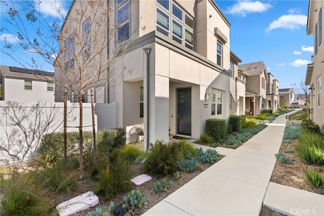 view of building exterior with a residential view and fence