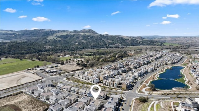 birds eye view of property with a residential view and a water and mountain view