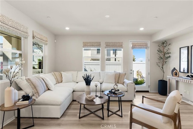 living area with light wood finished floors, baseboards, and recessed lighting