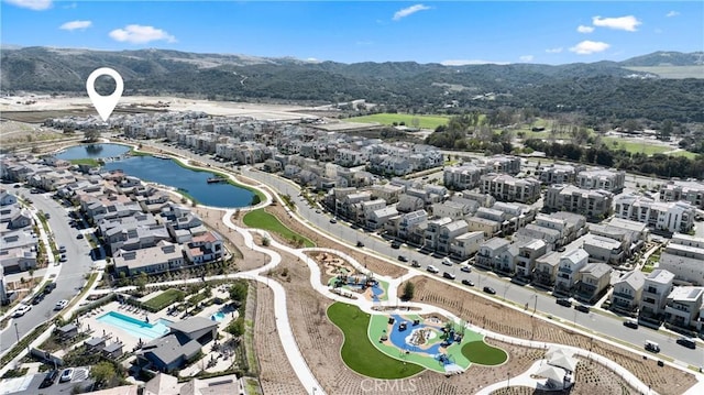 birds eye view of property with a water and mountain view and a residential view