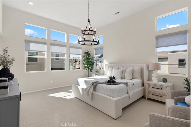 bedroom with light carpet, baseboards, visible vents, and a chandelier