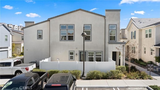 view of front of house featuring a fenced front yard and stucco siding