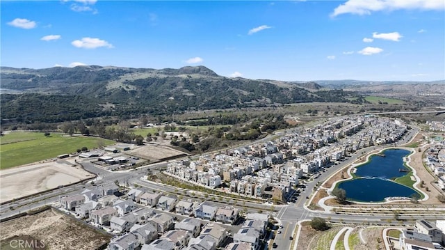 drone / aerial view featuring a residential view and a water and mountain view