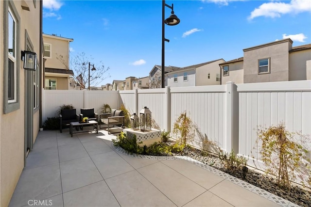 view of patio / terrace with a residential view, a fenced backyard, and outdoor lounge area