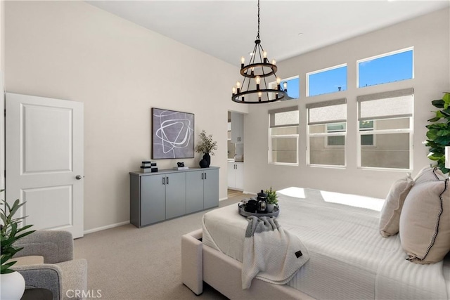 bedroom with baseboards, light carpet, and an inviting chandelier