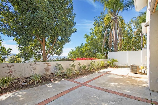 view of patio / terrace with central AC and a fenced backyard