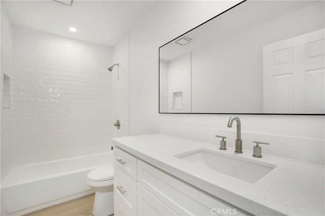 full bathroom with toilet, shower / bathtub combination, wood finished floors, and vanity