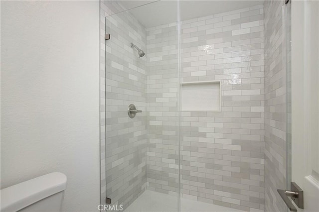 full bath with a shower stall and toilet