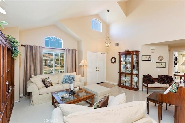 living room with high vaulted ceiling, light colored carpet, visible vents, and baseboards