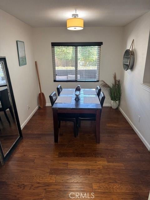 dining area with dark wood-style floors and baseboards