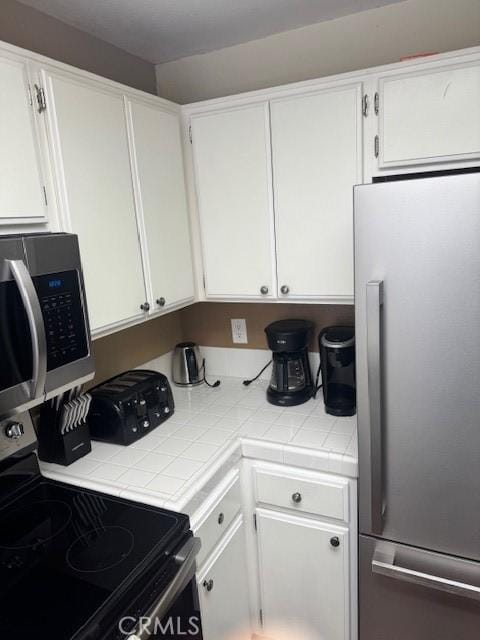 60 Corniche Dr Unit C, Dana Point, CA 92629 - kitchen featuring stainless steel appliances and white cabinetry