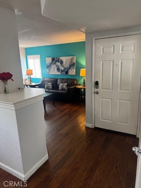 60 Corniche Dr Unit C, Dana Point, CA 92629 - entrance foyer with dark wood-type flooring and baseboards