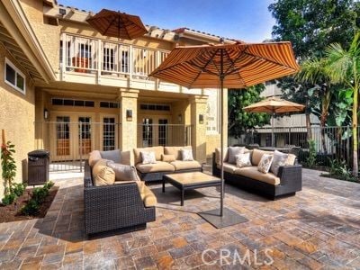 view of patio / terrace with a balcony, fence, and an outdoor hangout area