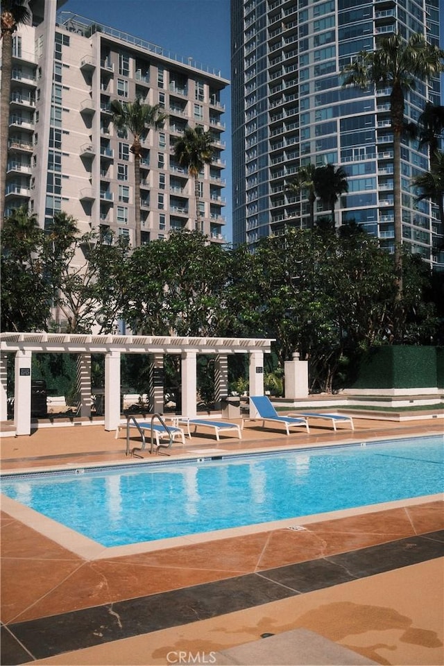 community pool with a patio area