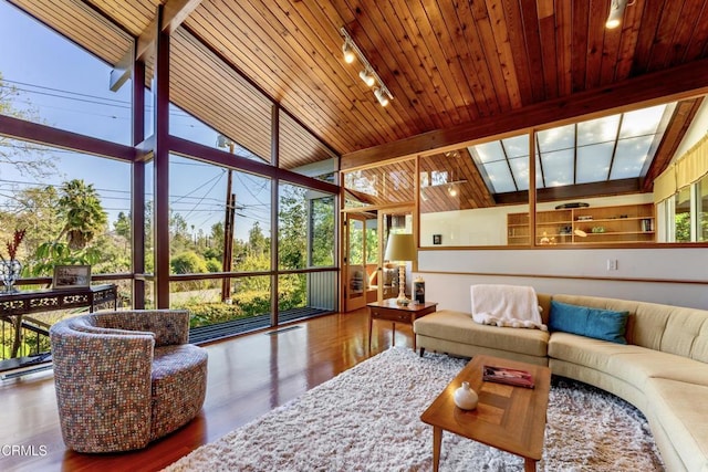 sunroom with wooden ceiling, plenty of natural light, and lofted ceiling with beams