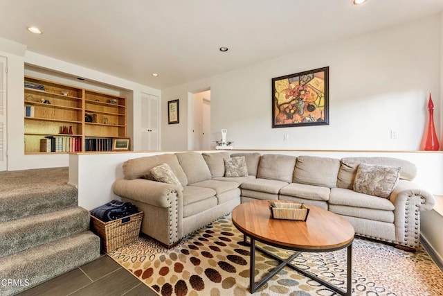 living room featuring stairs, built in features, and recessed lighting