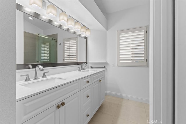 full bathroom with tile patterned flooring, a sink, baseboards, and double vanity