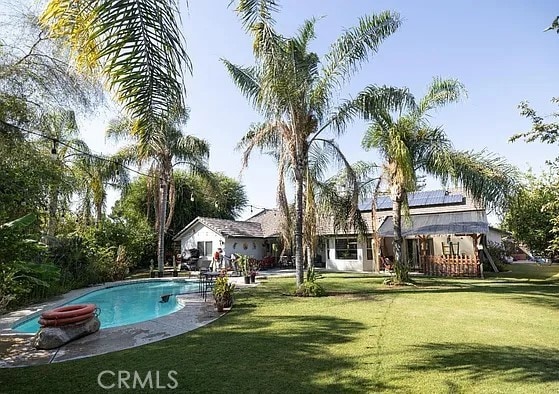 outdoor pool with a yard