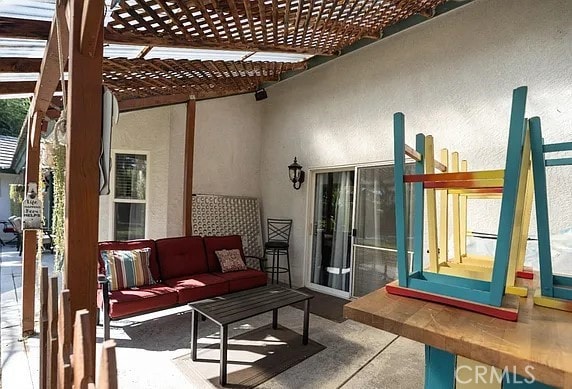 view of patio with outdoor lounge area and a pergola